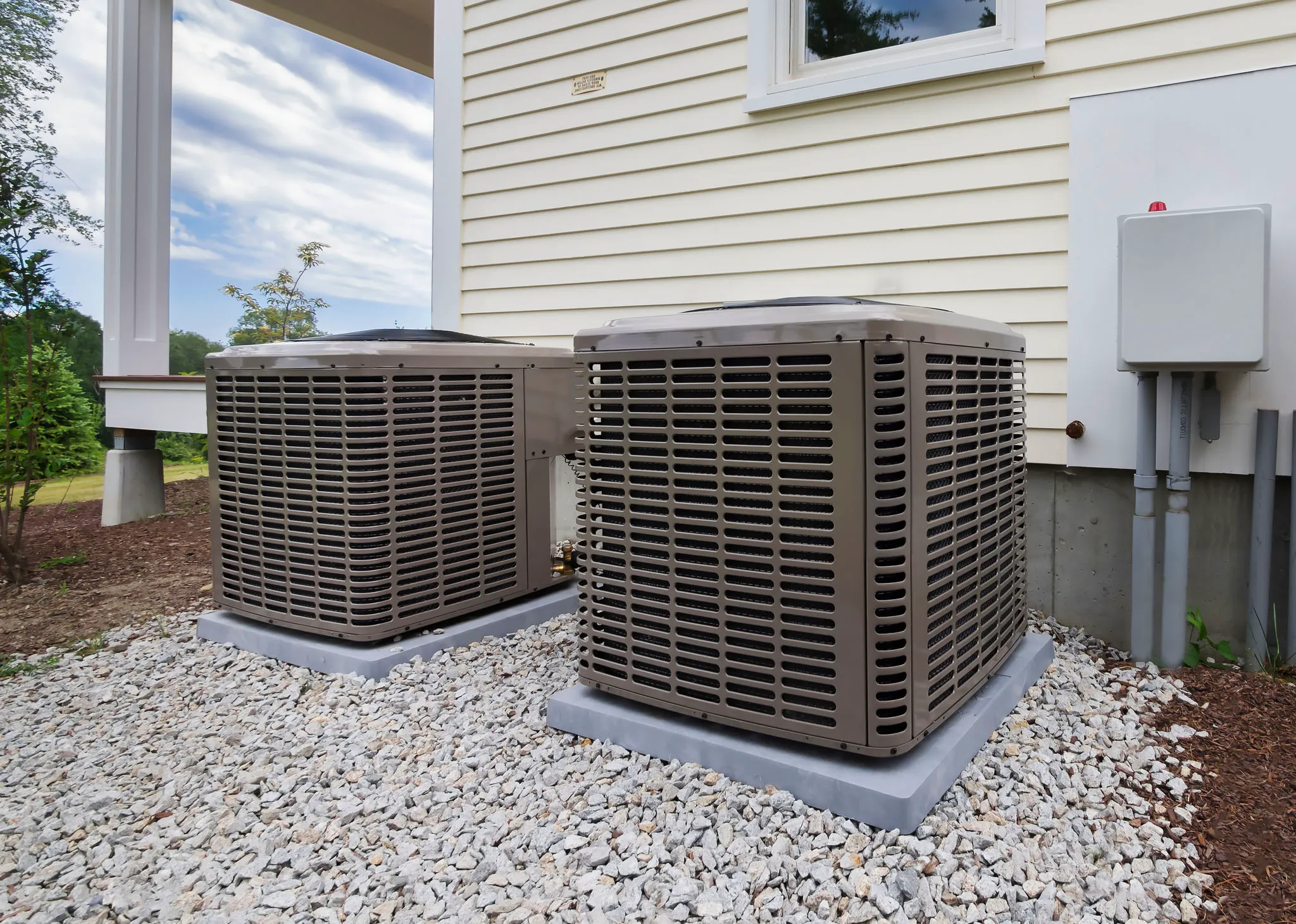 HVAC technician services heating system in residential property